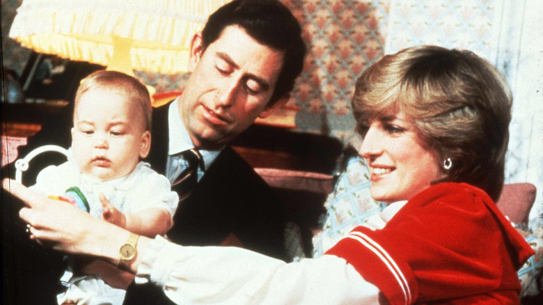 Princes Charles and Princess Diana pose with baby Prince William during Christmas