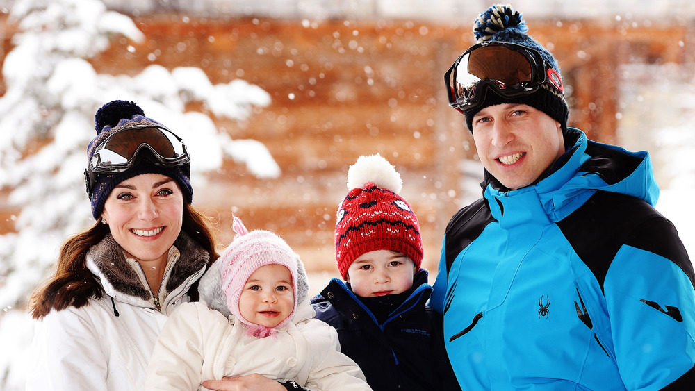 Kate Middleton, Prince William, and children smiling in ski gear
