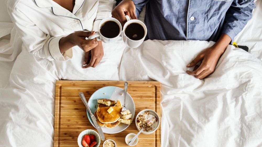 Couple drinking coffee in bed