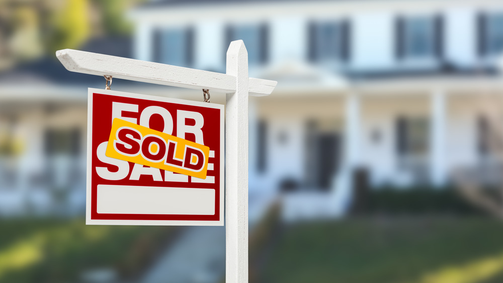Sold sign in front of house