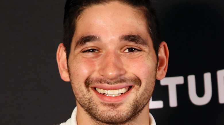 Dancer Alan Bersten smiles at an event. 