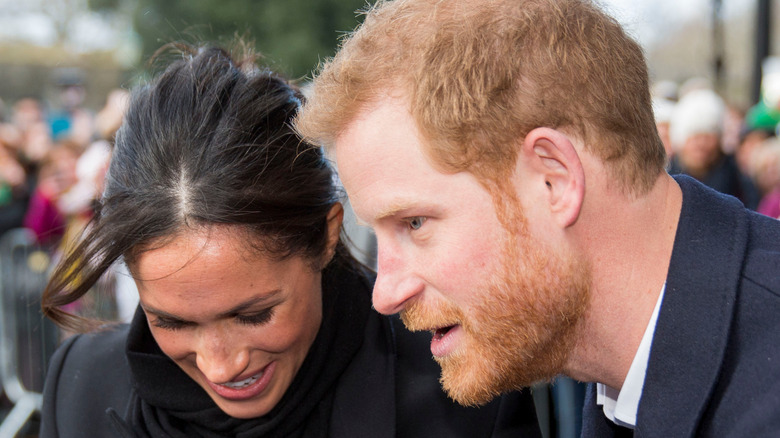 Prince Harry and Meghan Markle with crowd 