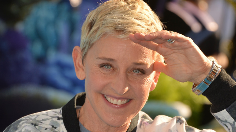 Ellen DeGeneres shields her eyes from the sun