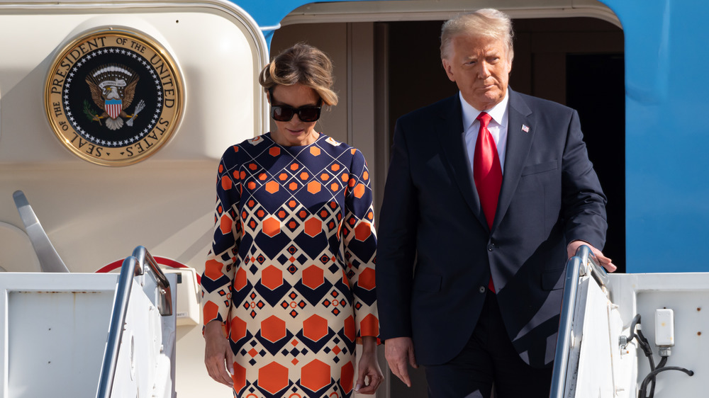 Melania and Donald descending airplane