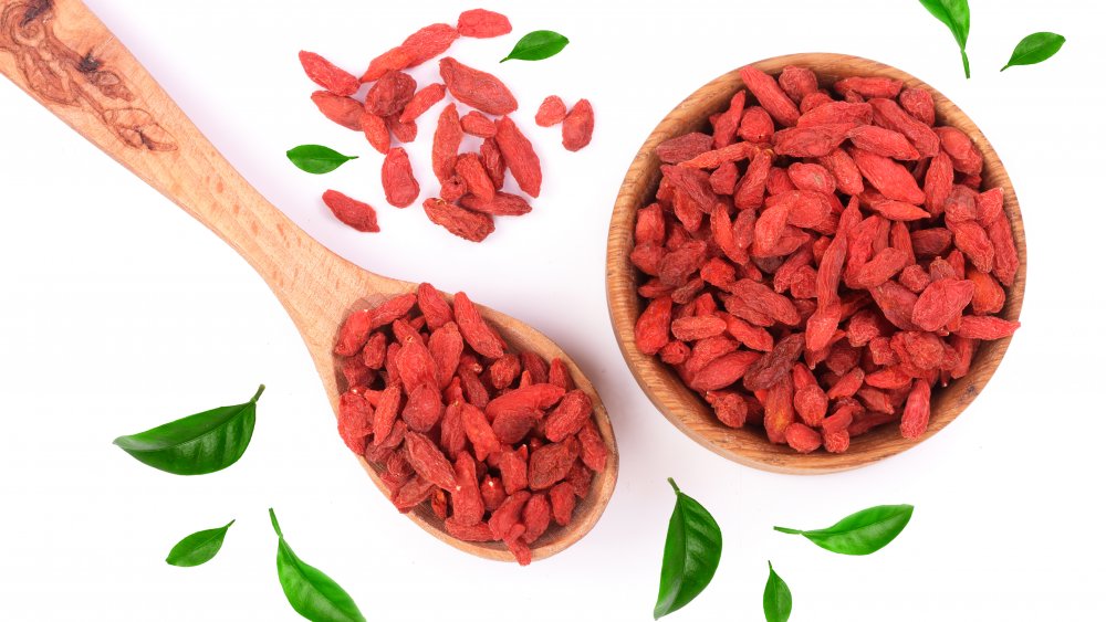 Dried goji berries in a wooden bowl