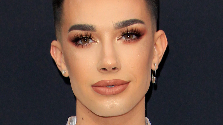 James Charles smiles at a red carpet event
