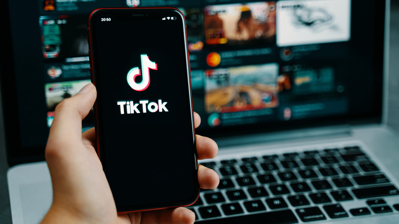 Person holding a phone with TikTok