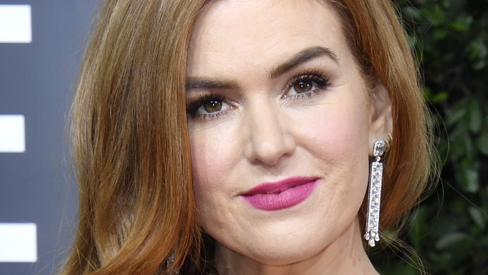 Isla Fisher grinning in pink lipstick