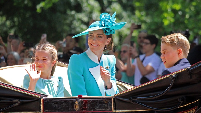 Princess Charlotte, Princess Kate, and Prince George in an open carriage