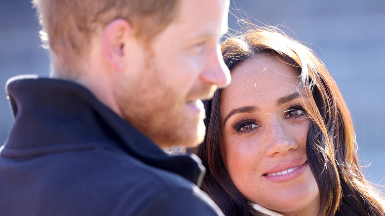 Meghan Markle smiling at Prince Harry