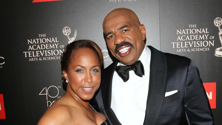steve and marjorie harvey pose on the red carpet