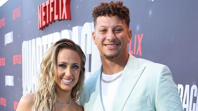 Brittany and Patrick Mahomes embrace at a premiere