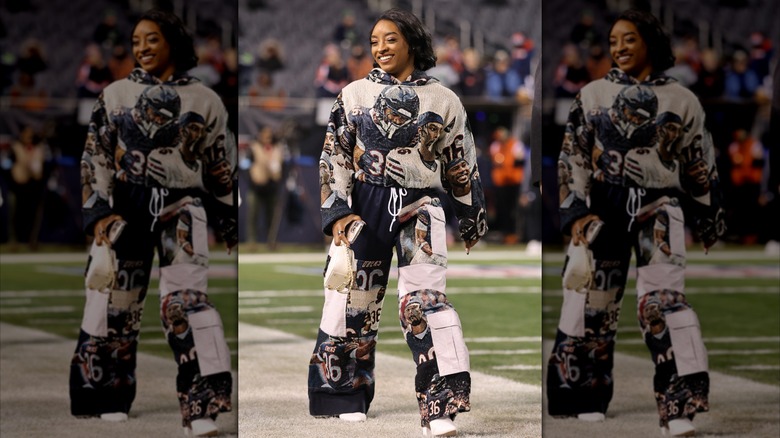 Simone Biles posing on a football field