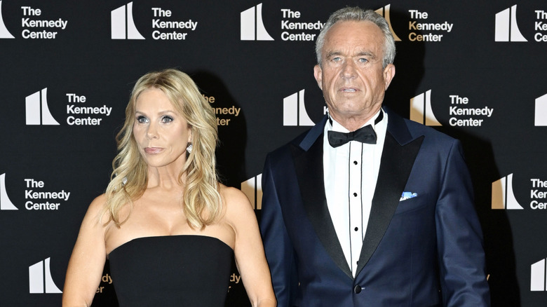 Cheryl Hines wearing a strapless black dress and posing next to Robert F. Kennedy Jr., who is wearing a tux, at The Kennedy Center.