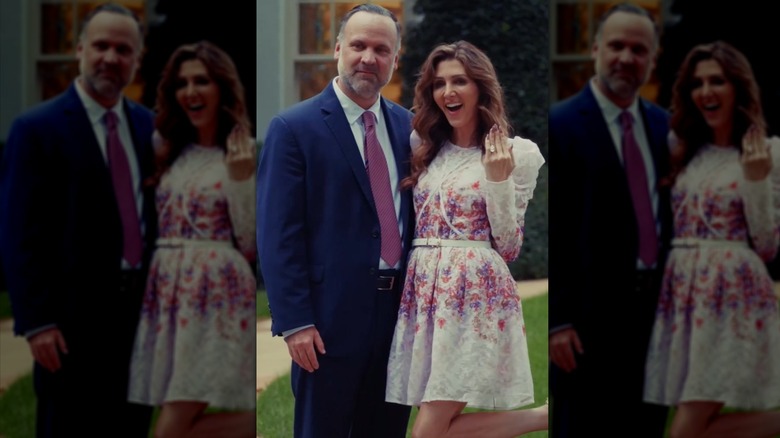 Dan Scavino smiling outside the White House beside Erin Elmore as she holds up her hand to show off her engagement ring.