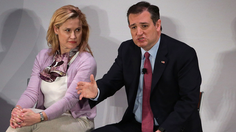 Heidi Cruz wearing a purple cardigan and turning her head to look at Ted Cruz as he speaks.