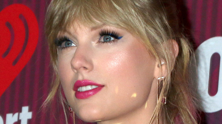 Taylor Swift smiling with blue eyeliner