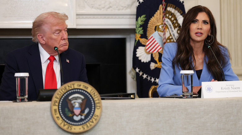 Donald Trump looking at Kristi Noem