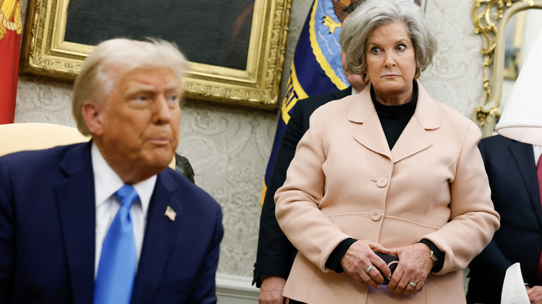 Susie Wiles looking at Donald Trump with widened eyes and a very stern expression on her face