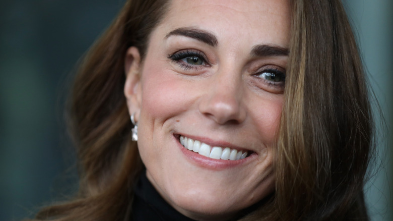 Kate Middleton smiles at an event. 