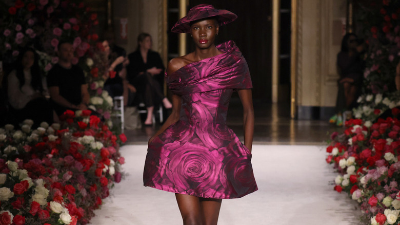 model walking runway in pink hooped-skirt dress