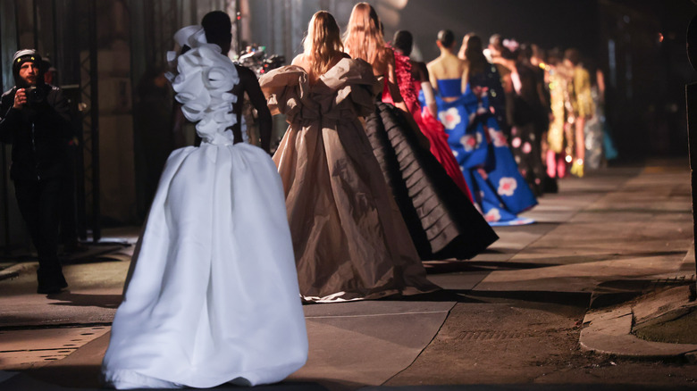 models wearing hoop skirt/dresses during fashion show