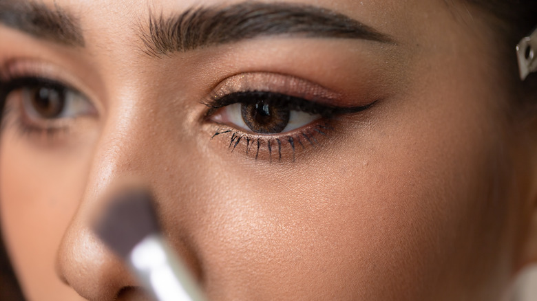 Woman applying makeup 