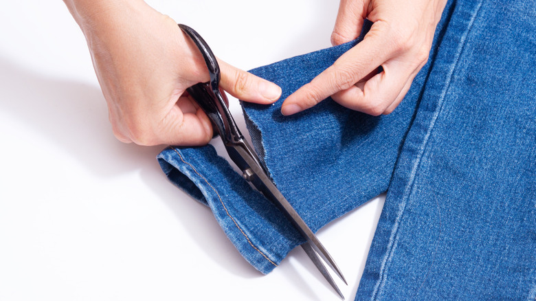 hands scissors cutting jeans