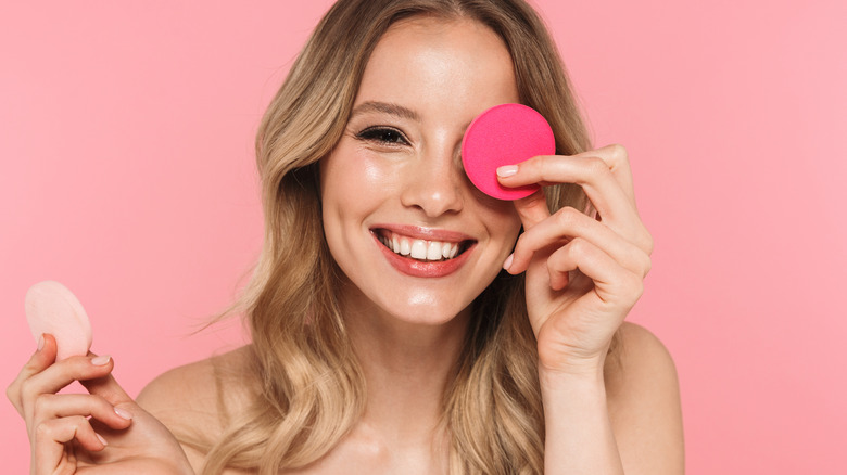 Girl holding makeup sponges