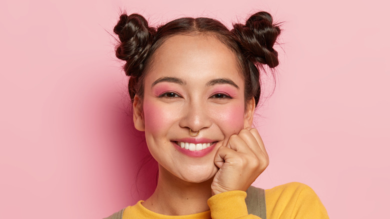 cheerful woman wearing pink blush