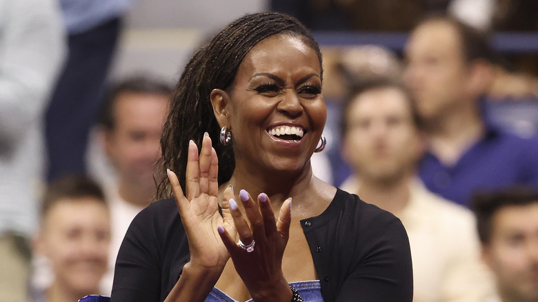 Michelle Obama laughing and clapping