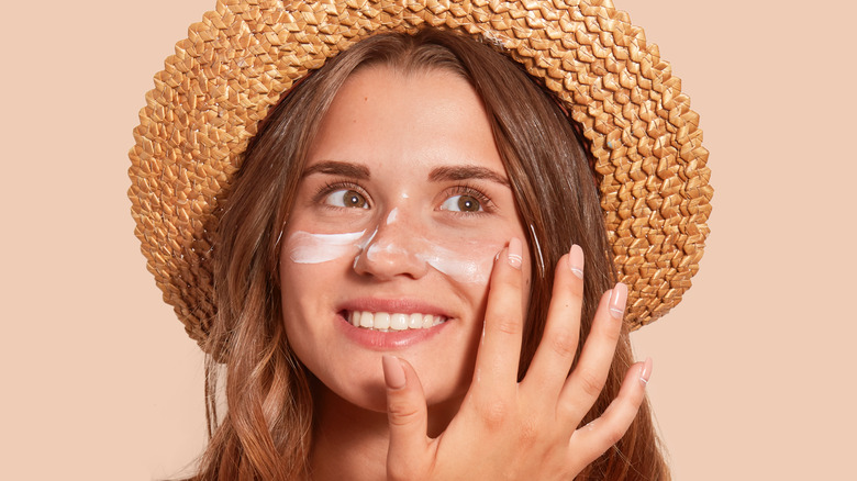 Woman applying sunscreen