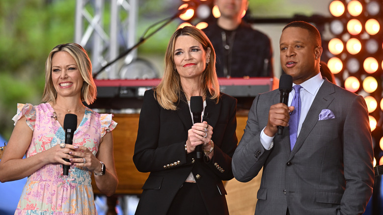 Dylan Dreyer, Savannah Guthrie, and Craig Melvin on stage holding microphones