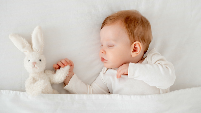 Baby sleeping with stuffed animal