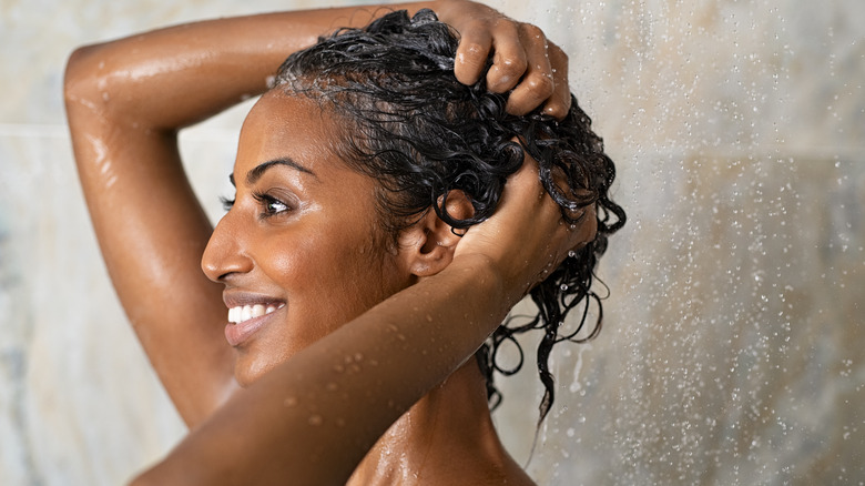 Woman shampooing her hair in the shower