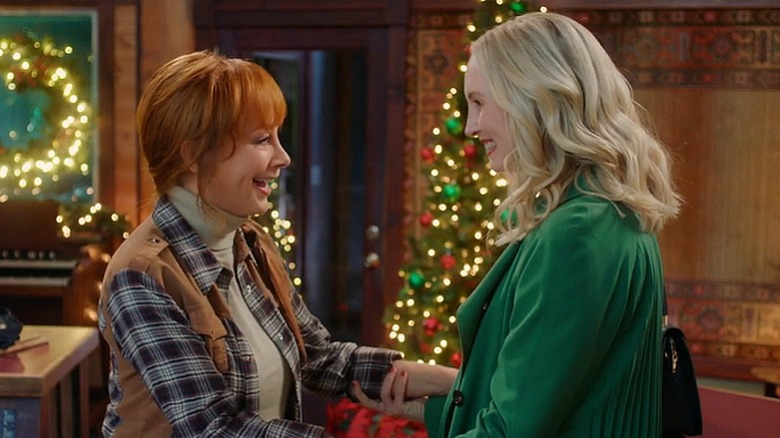 Reba McEntire (left) and Candice King (right) smiling at one another in 