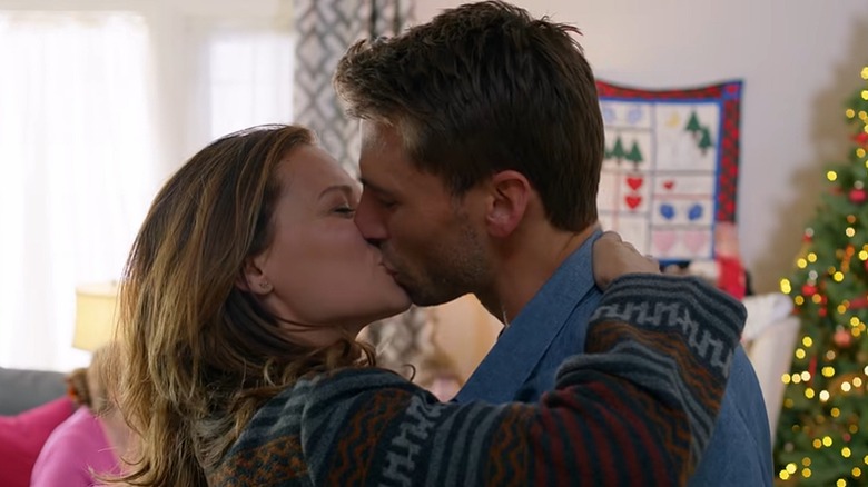 Bethany Joy Lenz (left) and Andrew Walker (right) kissing in "Snowed-Inn Christmas."