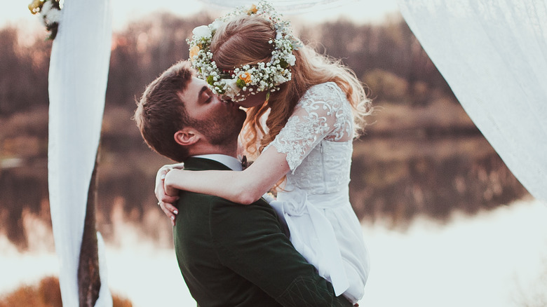 couple kissing on wedding day