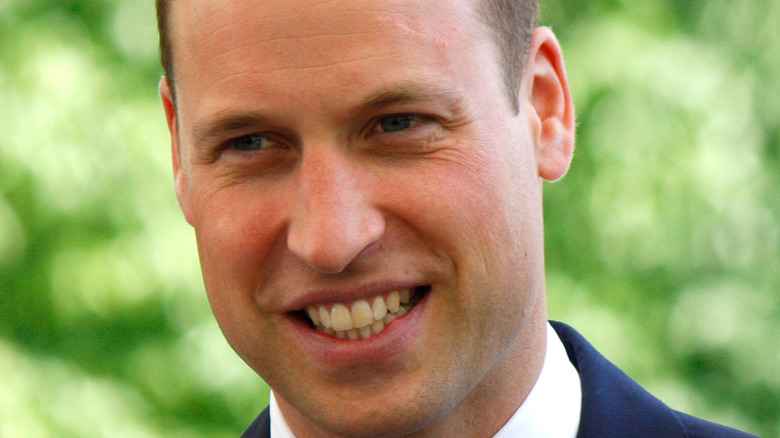 Prince William smiles at an event. 