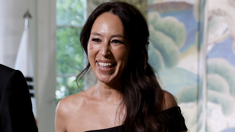 Joanna Gaines beams in a black dress