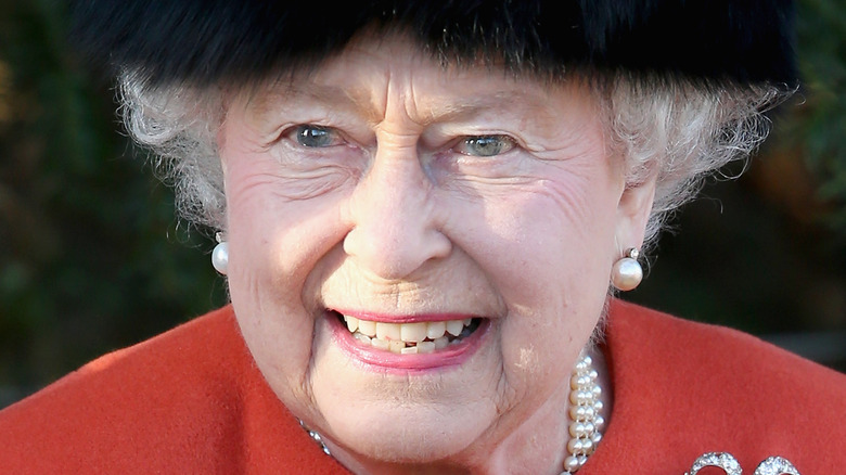 Queen Elizabeth II in fur hat smiling