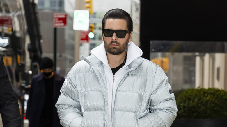 Scott Disick looking serious in a puffer jacket and sunglasses in December 2021
