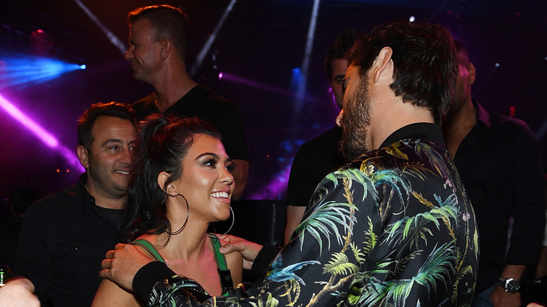 Scott Disick and Kourtney Kardashian embracing and smiling in May 2016