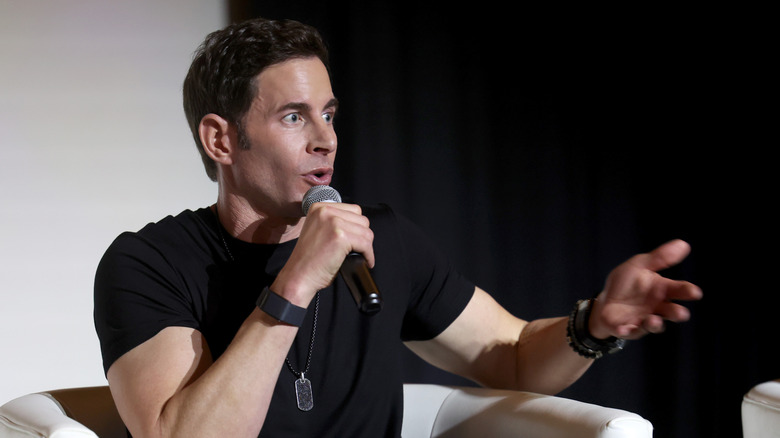 Tarek El Moussa talking into a microphone onstage in April 2025