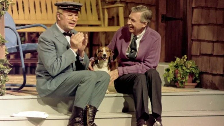 Mister Rogers and Mr. McFeely playing with a dog