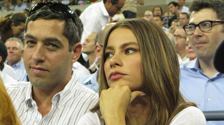 Sofía Vergara and Nick Loeb looking serious while watching a game