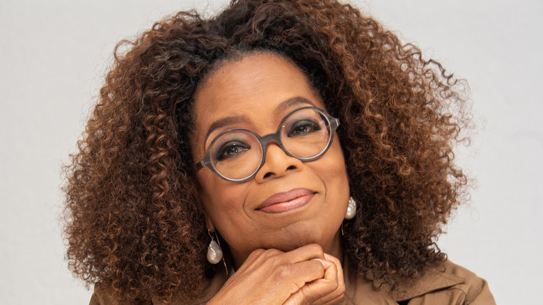 Bespectacled Oprah Winfrey smiling with serene benevolence