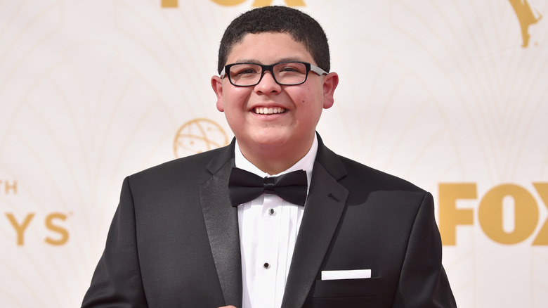 Rico Rodriguez smiling for photos