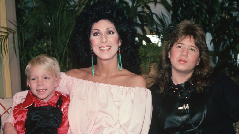 Elijah Blue Allman and Chaz Bono as kids posing for a photo with Cher