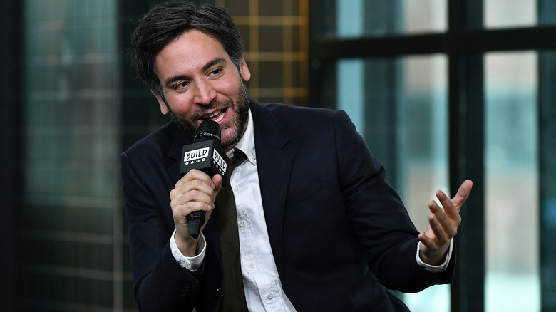 Josh Radnor speaking into a microphone
